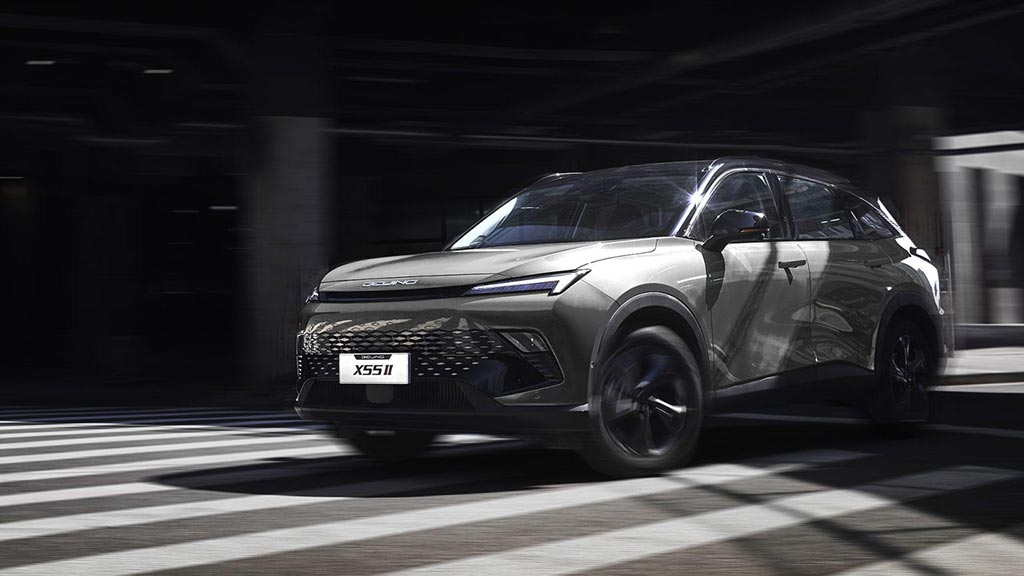 Black and white image of a BAIC X55 SUV driving past a pedestrian crossing in the city 