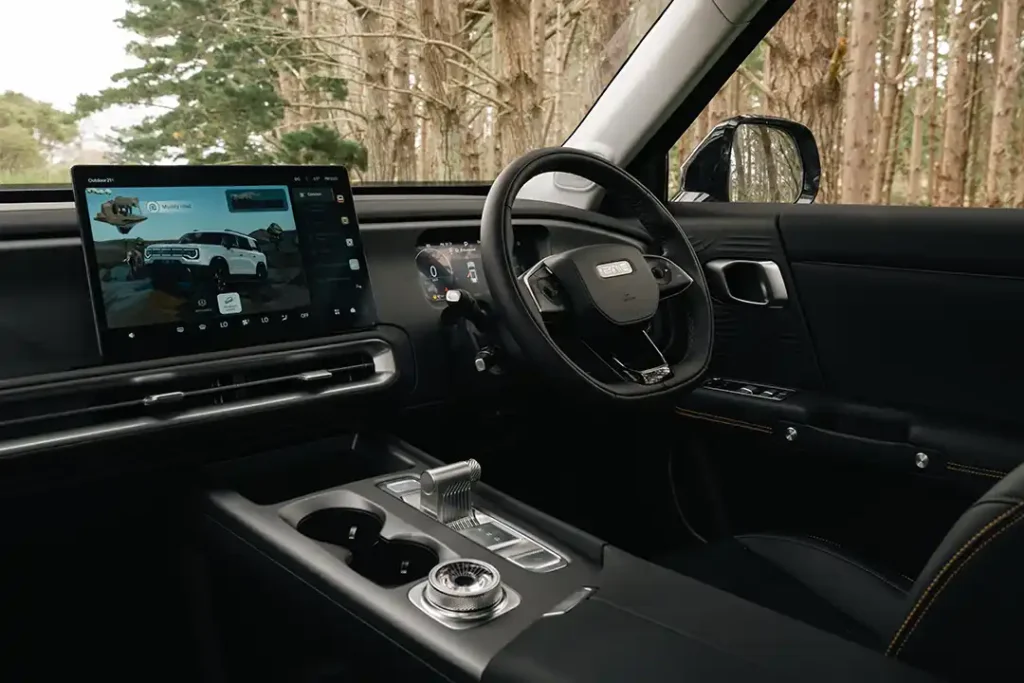 Interior view of the steering wheel and large central touchscreen of a BAIC B30 SUV parked in a NZ forest