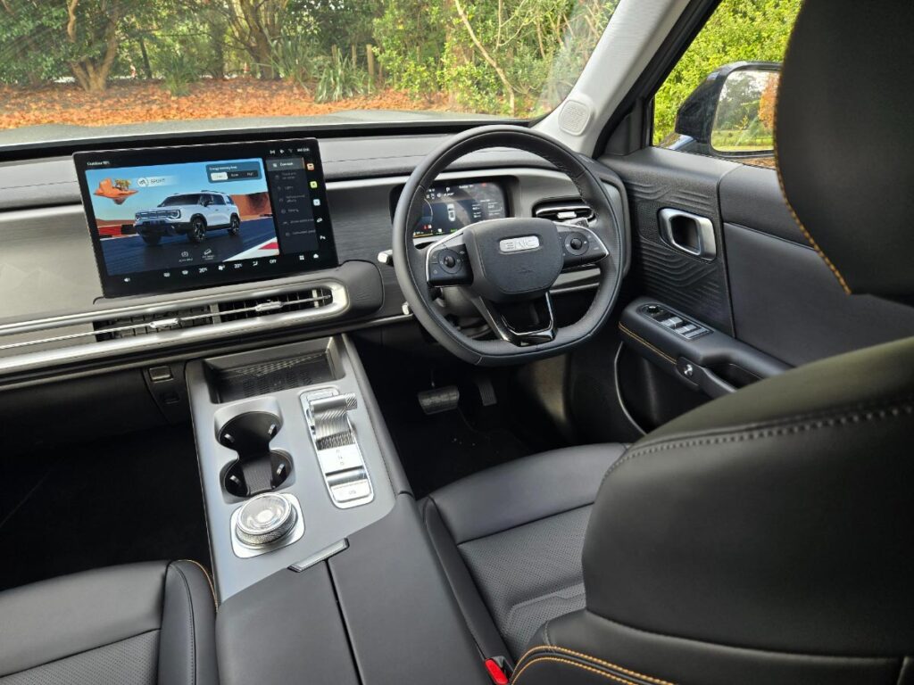 View of the dashboard, steering wheel and large centre touchscreen of a BAIC B30 hybrid SUV