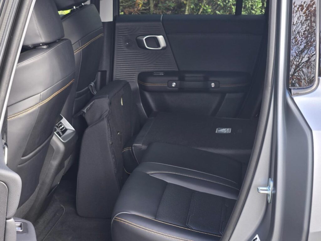 Rear seats of the BAIC B30 hybrid SUV with one of the seat squabs folded forward