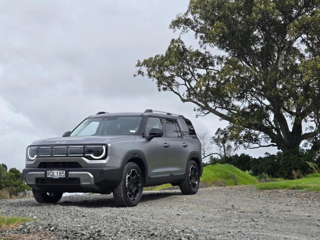 Front three quarter view of a silver BAIC B30 hybrid SUV parked on an unsealed gravel road