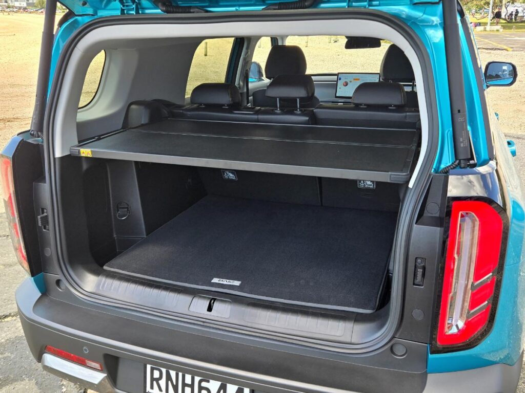 Open boot of a blue BAIC B30 showing the rear parcel shelf that can transform into a picnic table