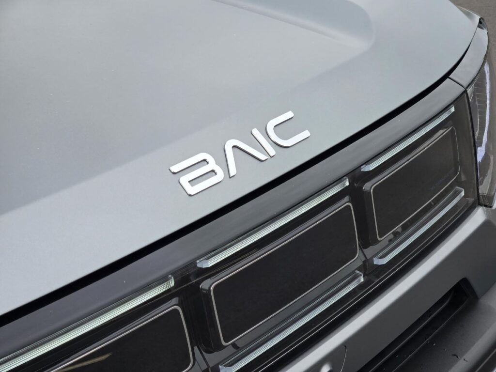 Close up of the front grille and BAIC badging on a silver BAIC B30 hybrid SUV